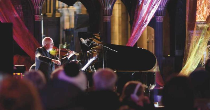 man playing violin at Hexham Abbey Festival of Music and Arts